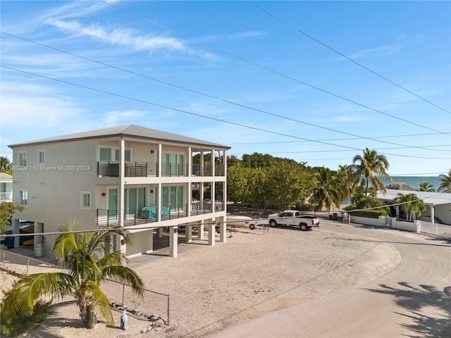 back of property featuring a balcony