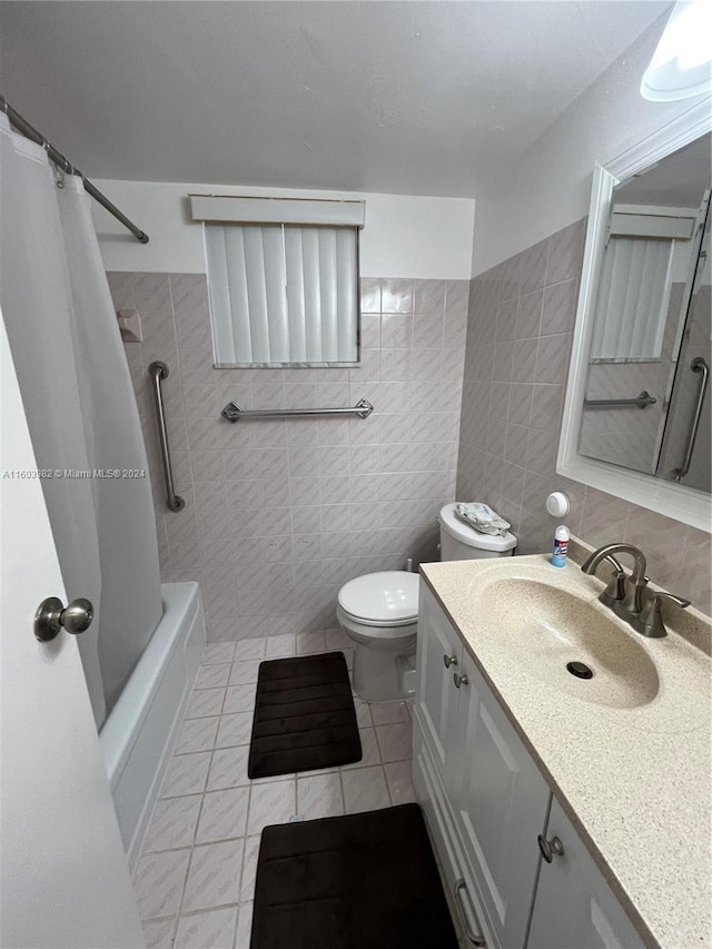 full bathroom with tile walls, vanity, toilet, and tile patterned flooring