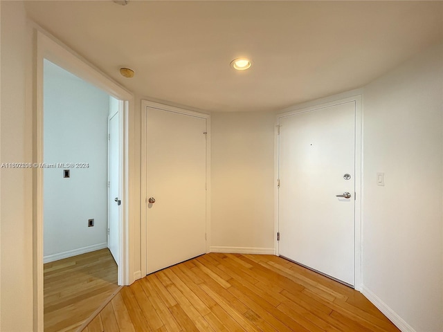 corridor with light wood-type flooring