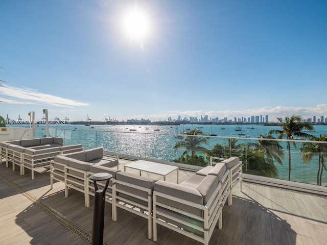 wooden deck featuring an outdoor hangout area and a water view