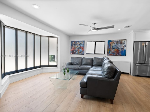 living room featuring ceiling fan and light hardwood / wood-style flooring