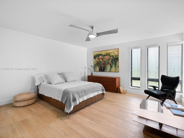 bedroom with light hardwood / wood-style floors and ceiling fan