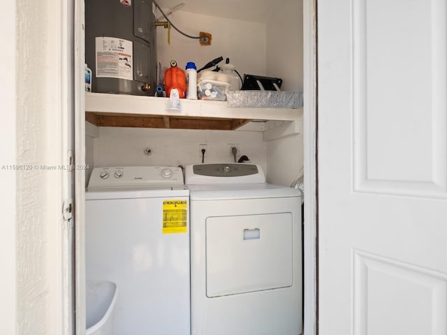 laundry area featuring water heater and washer and clothes dryer