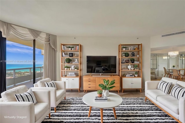 living room featuring a water view and dark hardwood / wood-style floors