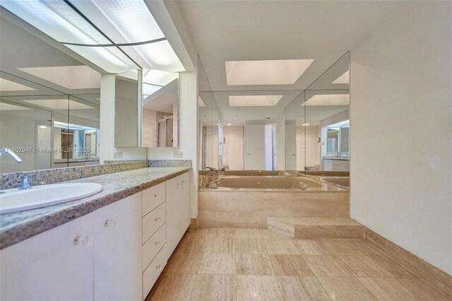 bathroom with vanity and independent shower and bath