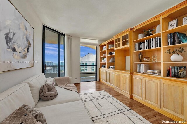 living area with light hardwood / wood-style floors and floor to ceiling windows