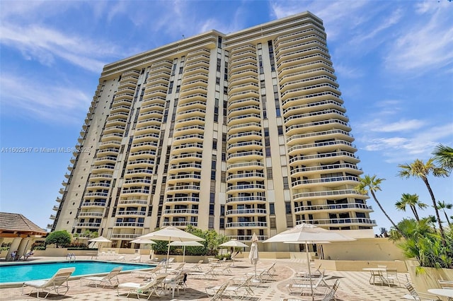 view of building exterior with a community pool