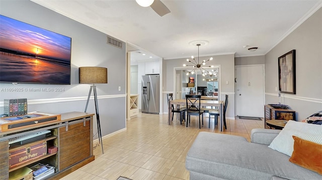 living room with ceiling fan with notable chandelier, crown molding, and light tile patterned floors