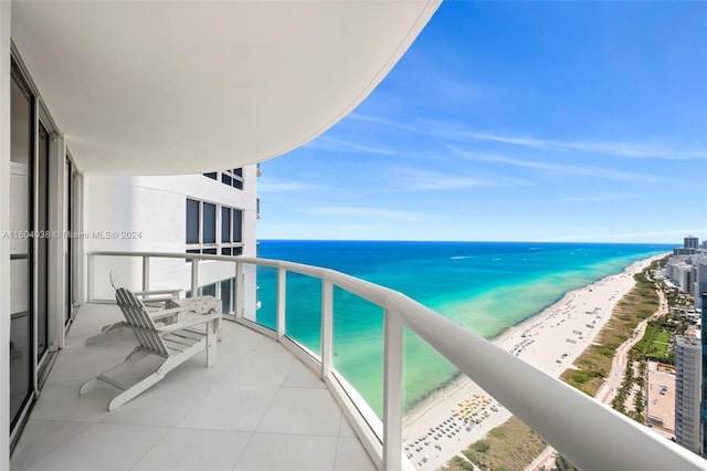 balcony with a beach view and a water view