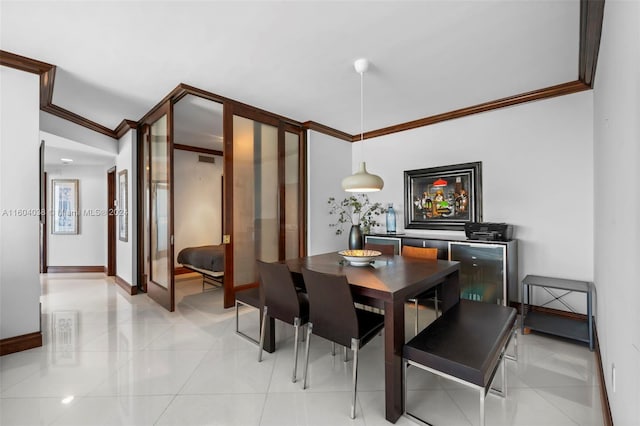 tiled dining room featuring ornamental molding