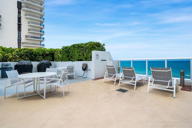 view of patio featuring grilling area and a water view