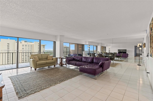 living room with a textured ceiling and light tile flooring