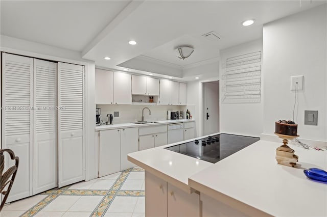 kitchen with black electric stovetop, a raised ceiling, white cabinets, sink, and light tile floors