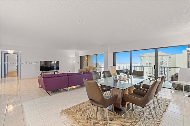 dining space featuring a textured ceiling and light tile floors