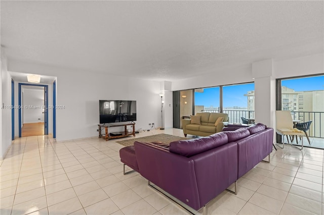 tiled living room featuring a textured ceiling