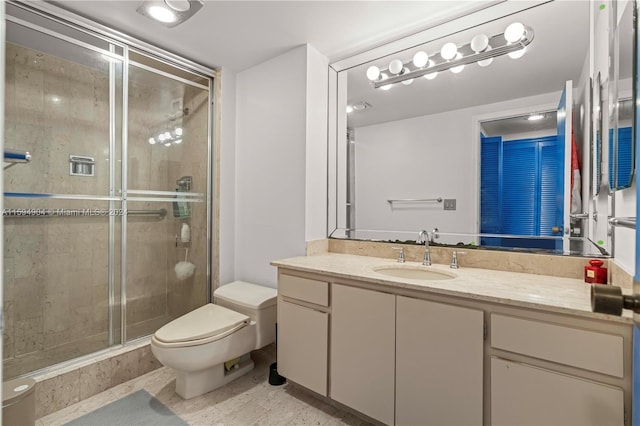 bathroom with tile floors, walk in shower, vanity, and toilet