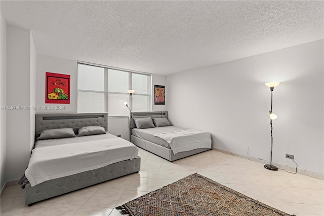 tiled bedroom with a textured ceiling