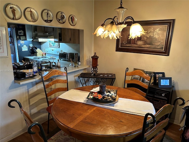 dining room featuring baseboards, a toaster, and an inviting chandelier