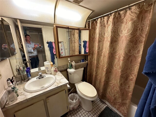 full bathroom with vanity, tile patterned floors, toilet, and shower / bath combination with curtain