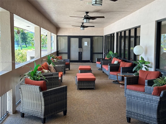 sunroom / solarium with a ceiling fan