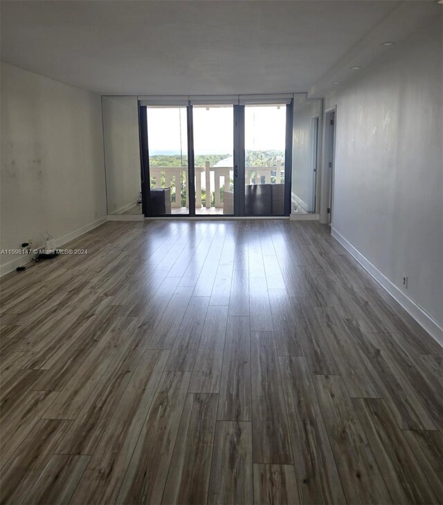 spare room with dark hardwood / wood-style floors