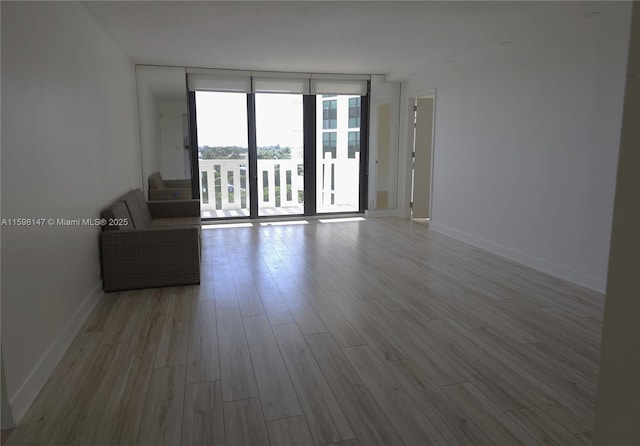 1121 Crandon Blvd Unit D604, Key Biscayne, FL 33149 - empty room featuring baseboards, wood finished floors, and a wall of windows