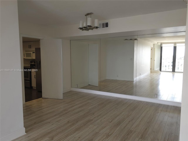1121 Crandon Blvd Unit D604, Key Biscayne, FL 33149 - spare room featuring light wood-type flooring, baseboards, and visible vents