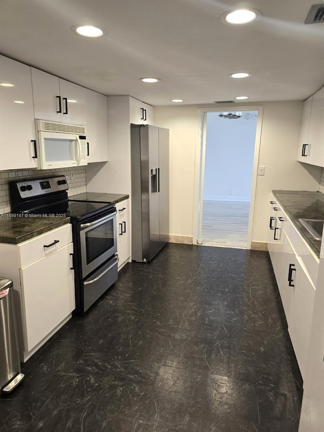 1121 Crandon Blvd Unit D604, Key Biscayne, FL 33149 - kitchen featuring white cabinets, dark countertops, visible vents, and appliances with stainless steel finishes