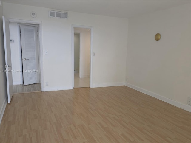 1121 Crandon Blvd Unit D604, Key Biscayne, FL 33149 - spare room featuring baseboards, light wood-style flooring, and visible vents