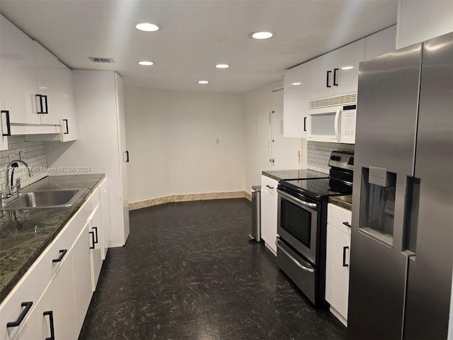 kitchen with white cabinetry, appliances with stainless steel finishes, sink, and tasteful backsplash