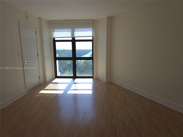 1121 Crandon Blvd Unit D604, Key Biscayne, FL 33149 - empty room featuring wood finished floors and baseboards