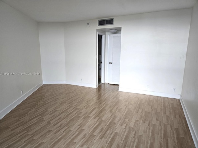 spare room featuring wood-type flooring