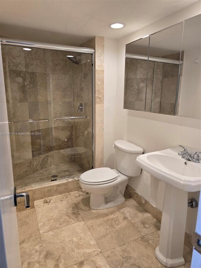 bathroom with walk in shower, toilet, and tile floors