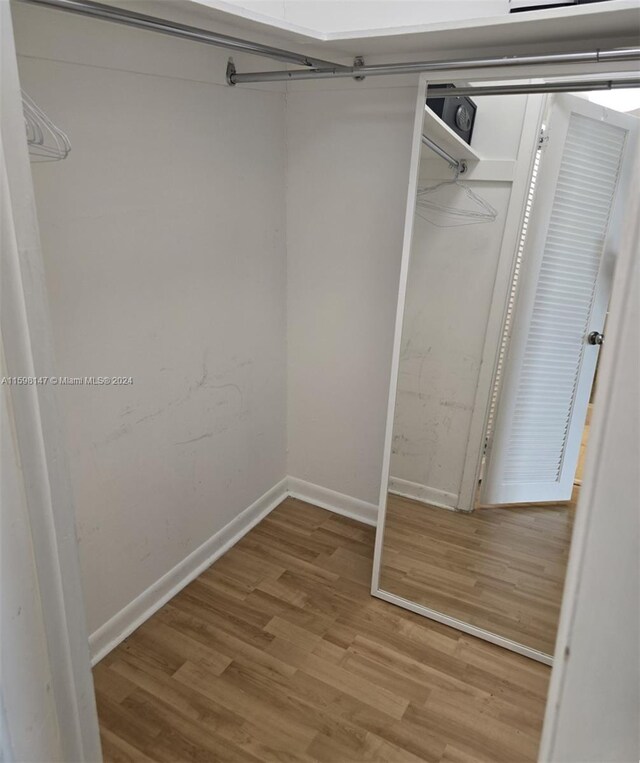 spacious closet featuring light hardwood / wood-style floors