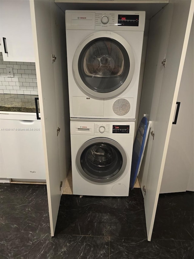 1121 Crandon Blvd Unit D604, Key Biscayne, FL 33149 - clothes washing area with stacked washer and dryer, marble finish floor, and laundry area