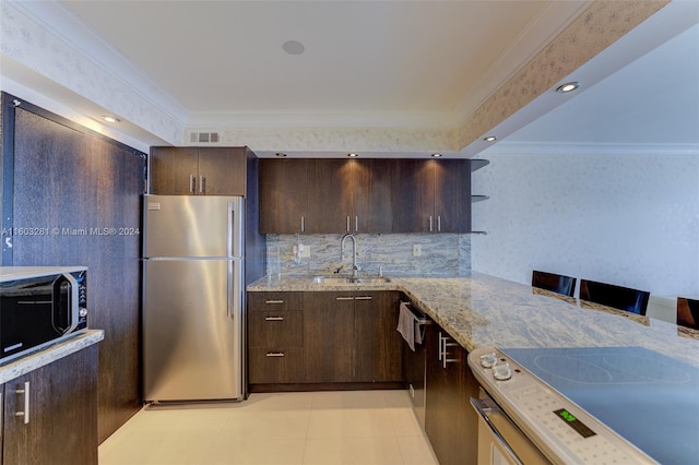 kitchen featuring dark brown cabinets, backsplash, light tile floors, sink, and appliances with stainless steel finishes