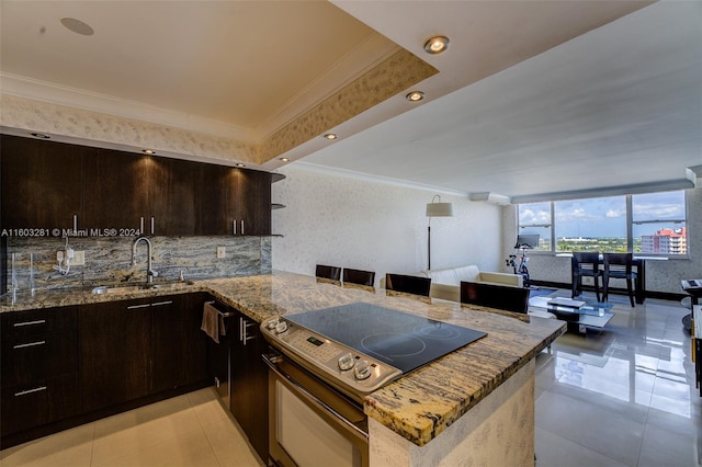 kitchen with kitchen peninsula, stone counters, light tile floors, sink, and electric range oven