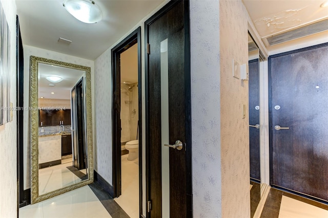 hallway with tile flooring