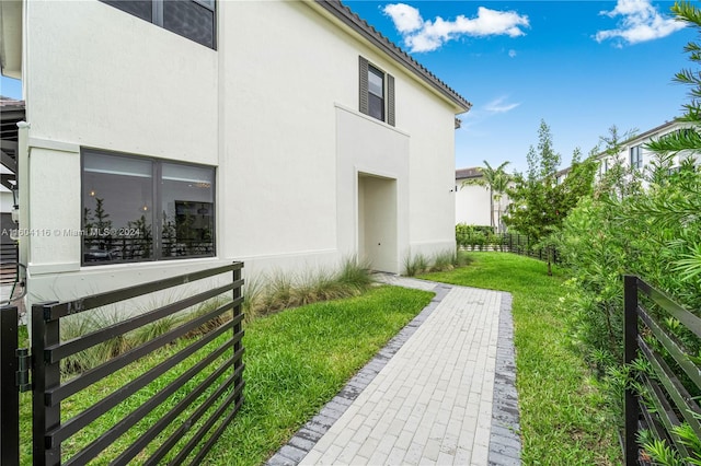 view of side of home with a yard