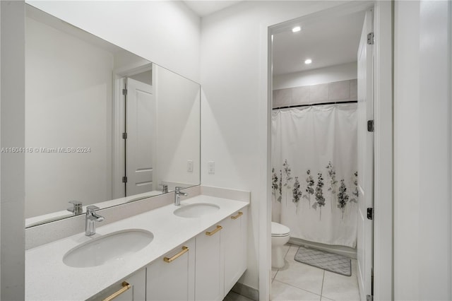 bathroom featuring toilet, vanity, and tile patterned flooring