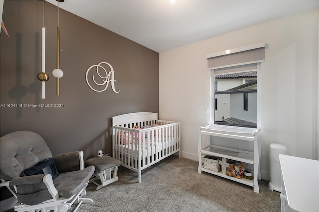 bedroom featuring carpet flooring and a crib