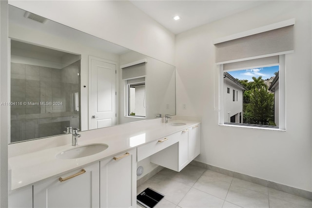 bathroom with vanity, walk in shower, and tile patterned flooring