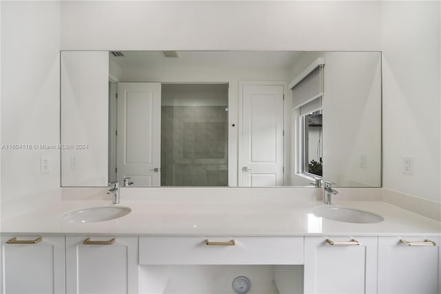 bathroom featuring vanity and tiled shower