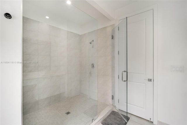 bathroom featuring an enclosed shower and tile patterned flooring