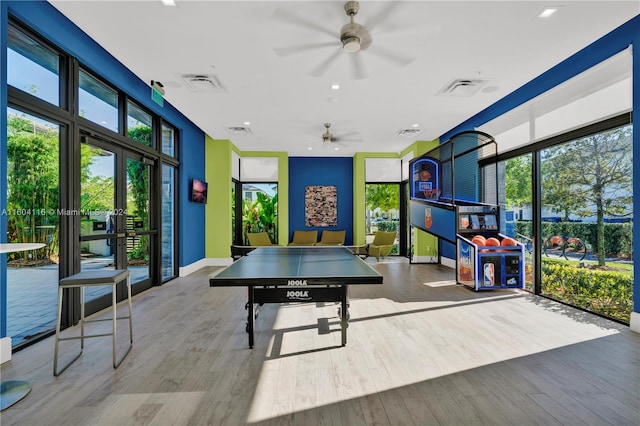 rec room with hardwood / wood-style floors, a healthy amount of sunlight, and ceiling fan