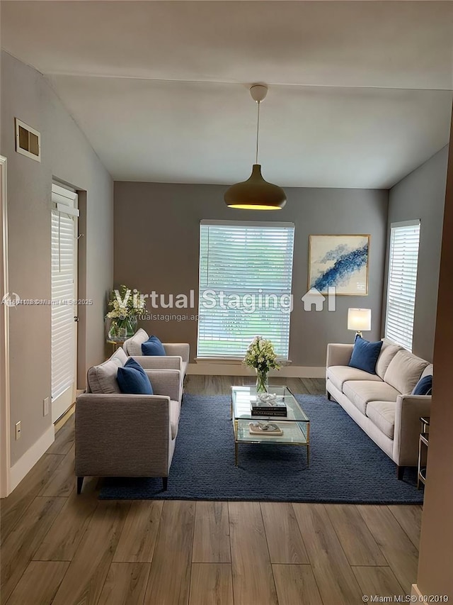 living room featuring hardwood / wood-style floors and vaulted ceiling