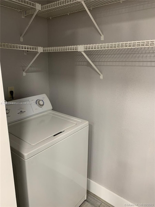 clothes washing area with washer / dryer