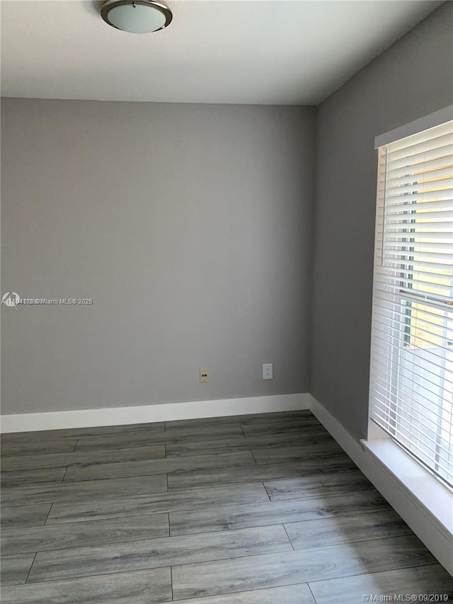 unfurnished room with hardwood / wood-style flooring