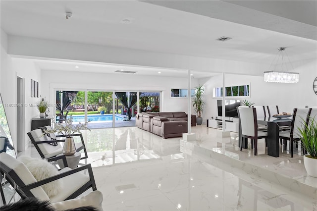 tiled living room featuring an inviting chandelier