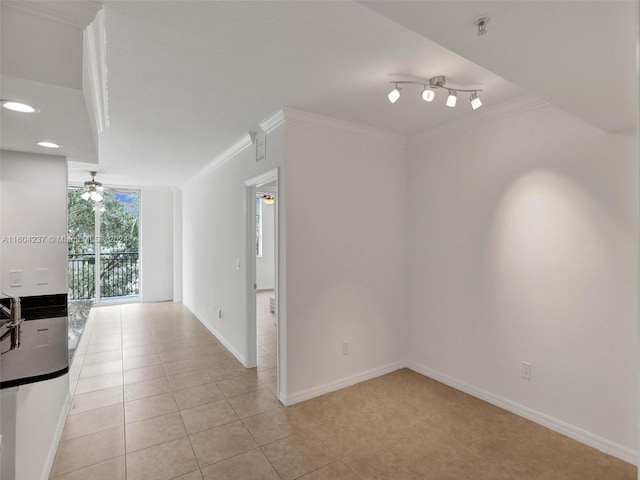 tiled spare room with ceiling fan and crown molding